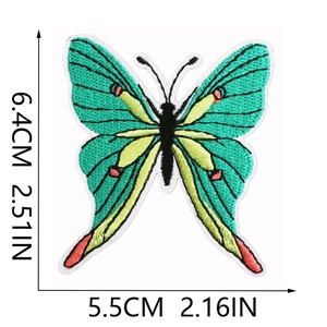 Macro detail of green butterfly embroidery patch with dimensions showing fabric texture