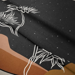 Close-up of bohemian wall tapestry fabric showing soft texture and line art print