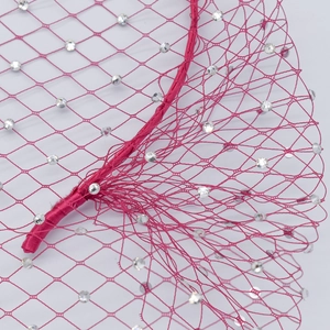 Macro detail of fuchsia bridal veil headband featuring honeycomb mesh and inlaid rhinestones