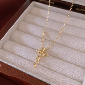 Vintage gold snake sword cross necklace with white zircon crystals in a luxury wooden box