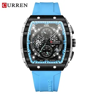 Men's blue silicone strap chronograph watch with black barrel-shaped case and multi-dial