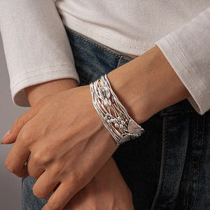 Detailed view of vintage silver wide cuff bracelet featuring hollow floral butterfly motifs
