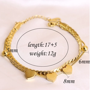 Detailed view of layered 18K gold stainless steel heart charm bracelet with size labels