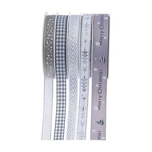 Detailed view of silver and grey Christmas ribbons with snow and star patterns