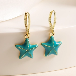 18K gold plated hoop earrings with turquoise starfish pendants on a white display stand