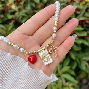 Handmade 18K gold plated pearl necklace with Virgin Mary and St. Benedict cross charms
