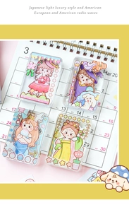 Close-up of cute acrylic charms with girl illustrations for scrapbooking decoration