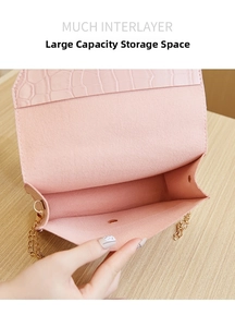 Interior view of pink faux leather chain bag showing spacious compartment and magnetic clasp