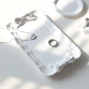 Elegant white ceramic jewelry tray with bow knots for ring and necklace display