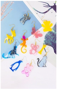 Showcase of glittery resin animal earrings and pendants made from DIY silicone molds