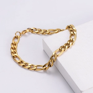 7mm wide gold plated stainless steel Figaro chain bracelet for men on white display