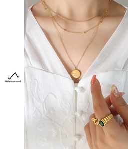 Three-layer stainless steel gold necklace with Good Luck pendant and emerald-style ring