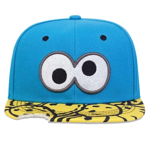 Detailed embroidery of cartoon eyes on a blue and yellow flat brim snapback hip-hop hat