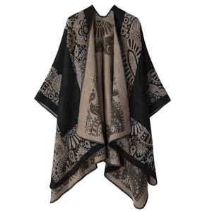 Close-up of knit shawl featuring intricate black and beige ethnic paisley patterns