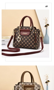 Detail of luxury PU leather handbag with geometric patterns and pearl heart pendant