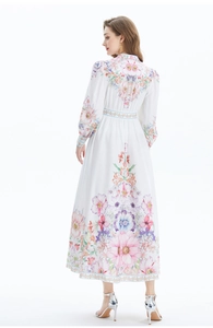 Rear view of floral linen long dress with lantern sleeves and a wide flowing hemline
