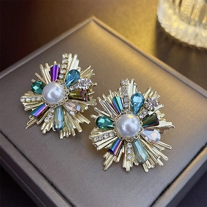 Macro shot of French vintage flower stud earring with colorful crystals and center pearl