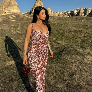 Detail of slim fit backless midi dress with brown leopard print and thin straps