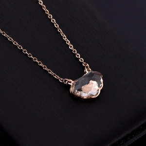 Rose gold stainless steel necklace featuring a crystal lucky lock pendant on black texture