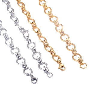 Polished gold and silver hip hop oval link chains with lobster clasps on white background
