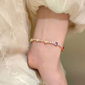 Elegant gold plated bracelet with colorful zircon square gemstones worn on a wrist