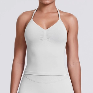 Detail of white seamless knitted sports bra with halter straps and ruching on the chest