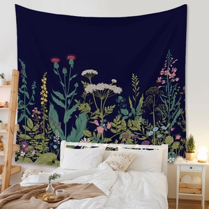 Detail of bohemian tapestry with botanical wildflower print over a bedroom headboard