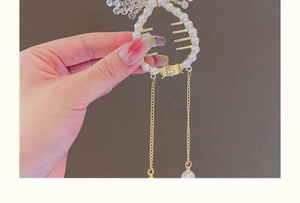 Détail de la pince à cheveux dorée avec perles et pompons pour coiffure de fille