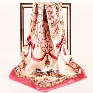 Detailed view of champagne satin scarf featuring vintage carriage palace pattern