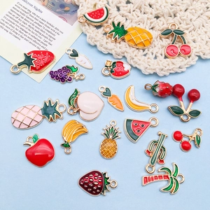 Assorted cute 3D fruit and vegetable alloy oil drip pendants on light blue background