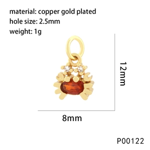 Macro detail of a 12mm gold plated crab charm with orange stone for jewelry making