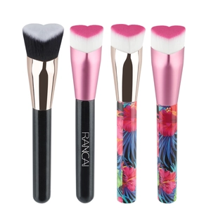 Set of four heart-shaped foundation brushes with soft bristles and ergonomic handles