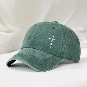 Vintage washed dark green baseball cap featuring a white faith cross print for outdoor wear
