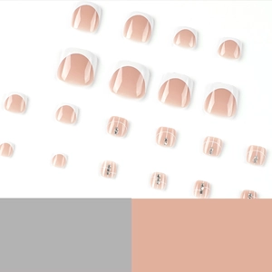 Short white French press-on nails set with rhinestones and grid pattern on white background