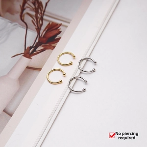 Minimalist S925 sterling silver ear cuffs in gold and silver finish on a book page