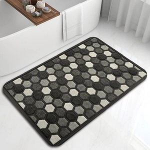 Detail view of the thick black border on a modern geometric honeycomb absorbent bath mat