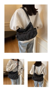 Detail of black denim messenger bag with multi-pocket utility design and crossbody strap