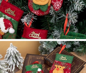 Detailed view of mini Christmas stockings with 3D Santa and elk figures on tree