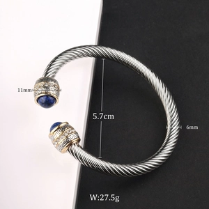 Detail of cable cuff bracelet with blue stone and gold accents showing 5.7cm diameter
