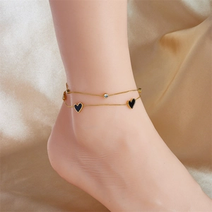 Double-layered gold anklet featuring a black heart charm and sparkling diamond accent