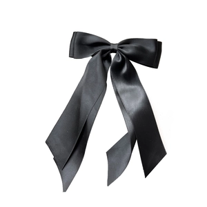 Elegant black double-layered satin ribbon bow hair clip with streamers on white background