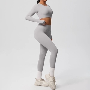 Close-up of light gray yoga set featuring long sleeve top with thumbholes and high waist leggings