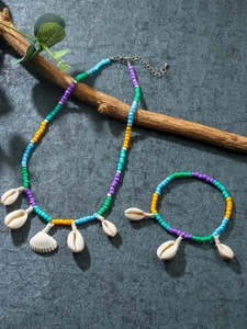 Detail of Bohemian beach jewelry set with colorful seed beads and natural shells