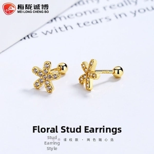 Macro detail of S925 sterling silver flower stud earrings with white zircon inlays