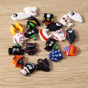 Flat lay of resin Halloween charms including pumpkin ghost and bat for DIY phone case decor