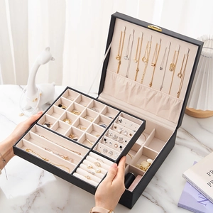 Detail of travel jewelry box showing ring slots and necklace hooks in high quality PU leather