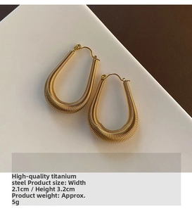 Detailed view of U-shaped gold titanium steel earrings with elegant spiral texture