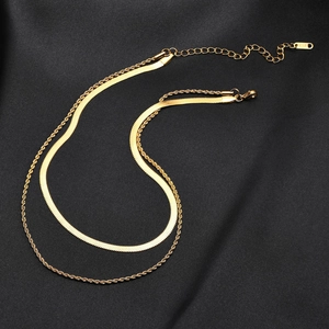 Close-up of gold double-layer snake and rope chain necklace with K18 engraving