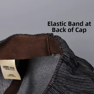 Detail of adjustable elastic back strap on vintage cotton newsboy cap with grey stripes
