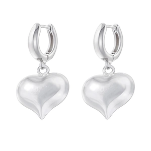 Detailed macro view of silver heart drop earrings with polished metallic finish and hoop design